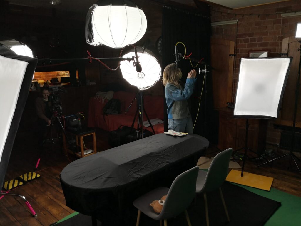 Sound recordist setting up boom microphones for a video shoot