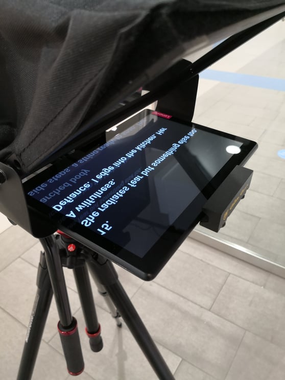 Teleprompter with a tablet showing a script.